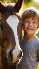 Portrait of happy  little boy with a horse on a nice summer day. Interacting with horses encourages emotional bonding and can help children develop trust, empathy, confidence and help reduce anxiety