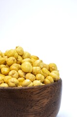 Closeup of Roasted Garbanzo Bean or Chickpea in a Wooden Bowl Isolated on White Background, Also Known as Bengal Gram or Egyptian Pea