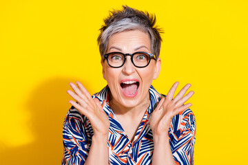 Photo of nice aged lady raise opened arms wear shirt isolated on yellow color background
