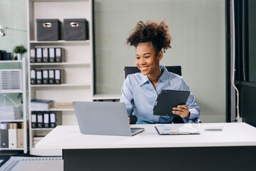 Confident business expert attractive smiling young woman holding digital tablet  on desk