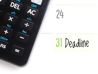 Due date concept: a calendar showing the text Deadline on the 31st and a black calculator. Cutoff,...