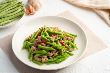 Stir Fried french green beans and Minced Pork with oyster sauce in white plate