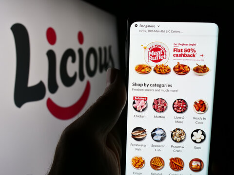 Stuttgart, Germany - 05-16-2024: Person holding smartphone with website of Indian food delivery company Licious in front of business logo. Focus on center of phone display.