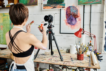 A woman teaching how to paint on camera.