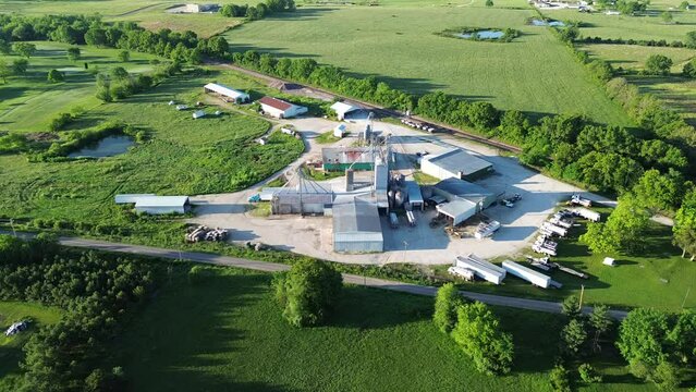 Flyover large feed mill agro processing plant grain silos, griding machines, warehouses, storage tanks, fertilizer miller in Mountain Grove, South Central Missouri, agricultural service facility