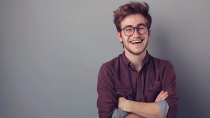 Obraz premium Portrait of young handsome smiling business guy wearing gray shirt and glasses, feeling confident with crossed arms, isolated on white background