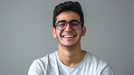 Portrait of young handsome smiling business guy wearing gray shirt and glasses, feeling confident with crossed arms, isolated on white background