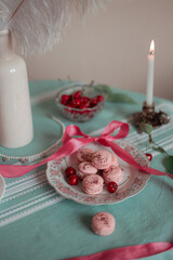 pink macarons served with cherries 
