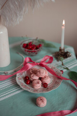 pink macarons served with cherries 