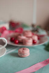pink macarons served with cherries 
