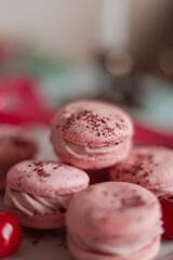 pink macarons served with cherries 