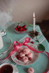 pink macarons served with cherries 