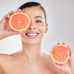 Studio, grapefruit and face of woman, smile and brightening of skin, beauty and wellness with...