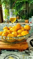 transparent glass bowl with portion of baked potato on table in restaurant and bar