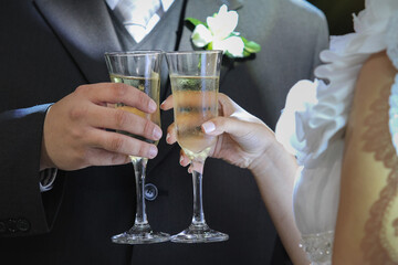 Wedding couple with champagne glasses toasting during wedding party