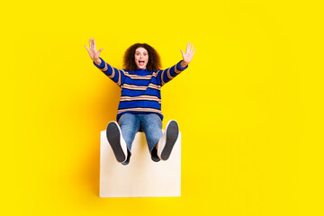 Full length photo of astonished girl dressed knit sweater falling from platform raising palms...