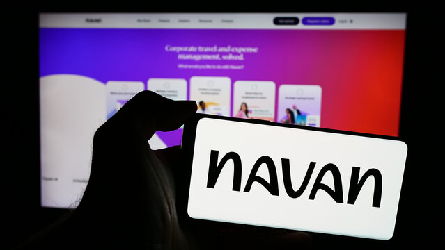 Stuttgart, Germany - 05-17-2024: Person holding mobile phone with logo of US travel management software company Navan Inc. in front of business web page. Focus on phone display.