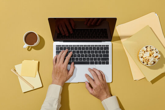 Male hands using laptop in office while working