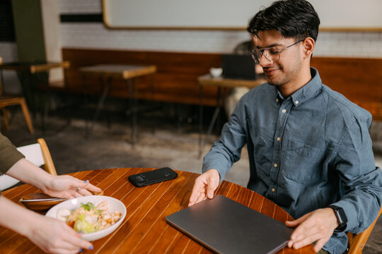 The waiter brings lunch to the man