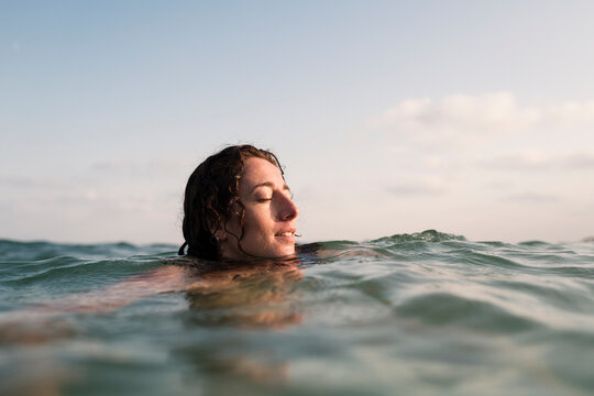 Enjoying relaxing sea bathing during summer sunset