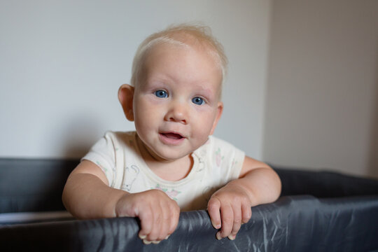 Baby girll looking out of the cot