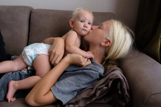 Elder sister kisses her baby sister at home