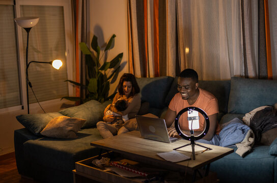 
A FAMILY IN THE LIVING ROOM OF THEIR HOUSE