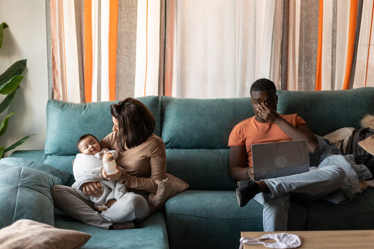 
A FAMILY IN THE LIVING ROOM OF THEIR HOUSE