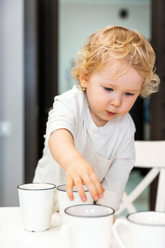 Child Playing With Cups