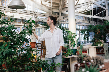 Portrait of a man enjoying his indoor garden