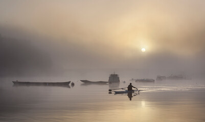 A single rower at sunrise