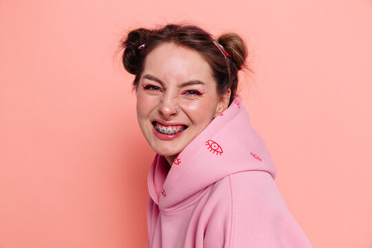 Smiling young woman in casual wear. Funny girl with braces