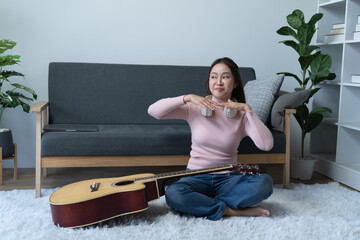 Young singer fun woman wear casual clothes stand near sofa couch using laptop listen music in...