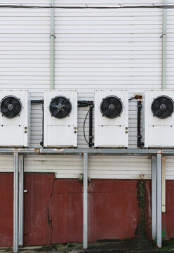 Multiple ventilation systems installed on a white wall.