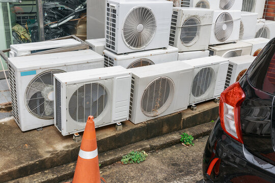 There are a lot of broken air conditioners piled up.