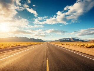 Naklejka premium Perspective view of an endless road stretching through a vast, open landscape with blue skies, fluffy clouds, and distant mountains, conveying a sense of freedom and adventure