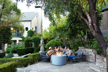 Group of friends doing toast with wine at hotel.