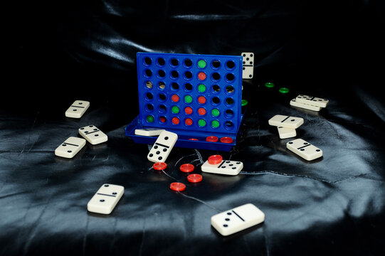 Strategic and tactic connect four game on leather sofa with flashlight