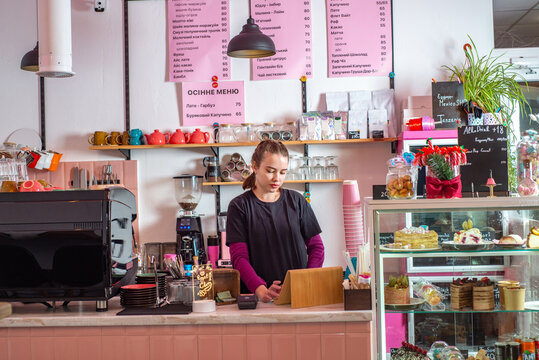 Coffee shop owner businesswoman standing behind the counter