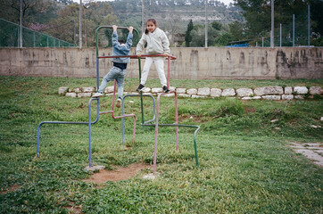 Children Playing On Monkey Bars In Park. Playtime At The Playground.