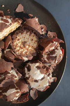 Messy chocolate, cream and cookie dessert on a plate