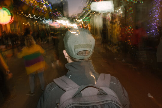Man Waking Down Crowded Bourbon St in New Orleans at Night