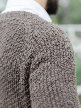 Close up of sweater knit from handspun yarn worn on a man