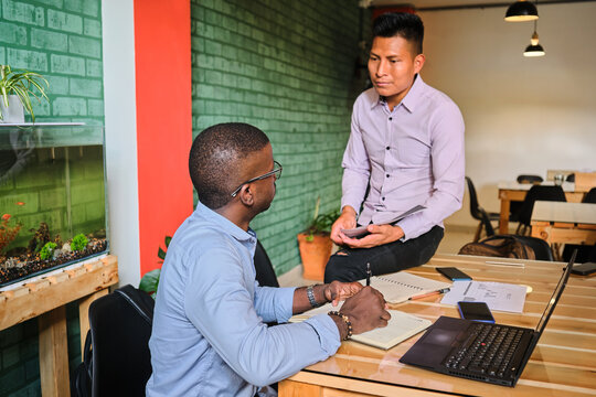Man assisting his colleague in the office