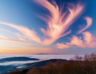 Obraz premium Stunning romantic and relaxing sunrise with some pink illuminated clouds moving across a blue sky. Long exposure, natural background.