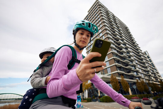 Woman riding a bike while using the phone