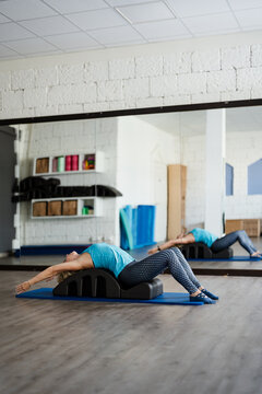 woman doing postural exercises for back pain at the gym