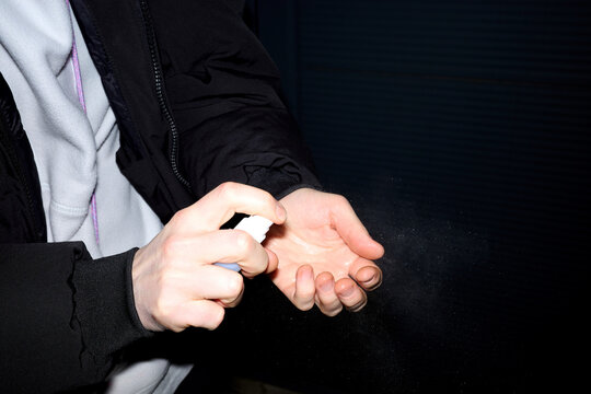 Hand sanitizing in dim light (close up shot)