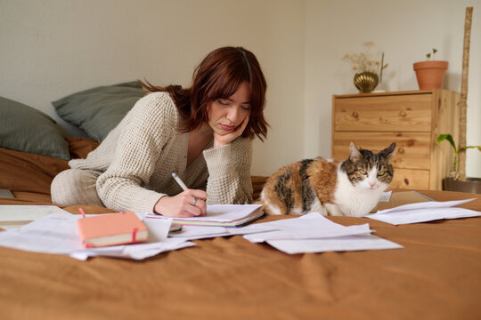 Writing in her journal with cat t home