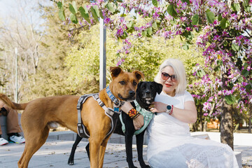 Portrait of a woman with her pets looking at camera.